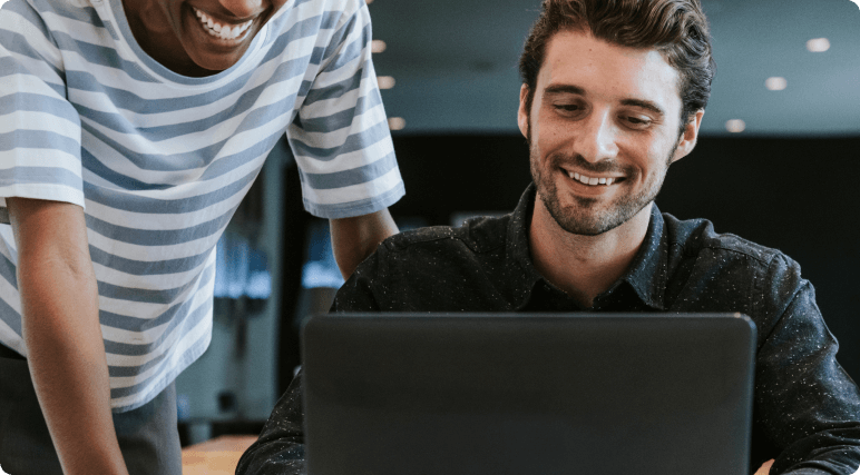 Colegas de trabalho em frente a uma tela de notebook.